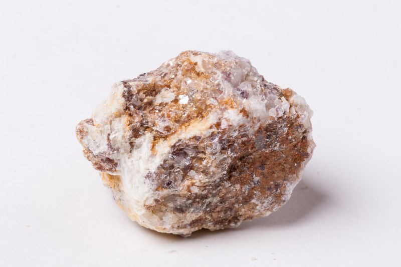 lepidolite stone on a white background, lepidolite is a primary source of lithium