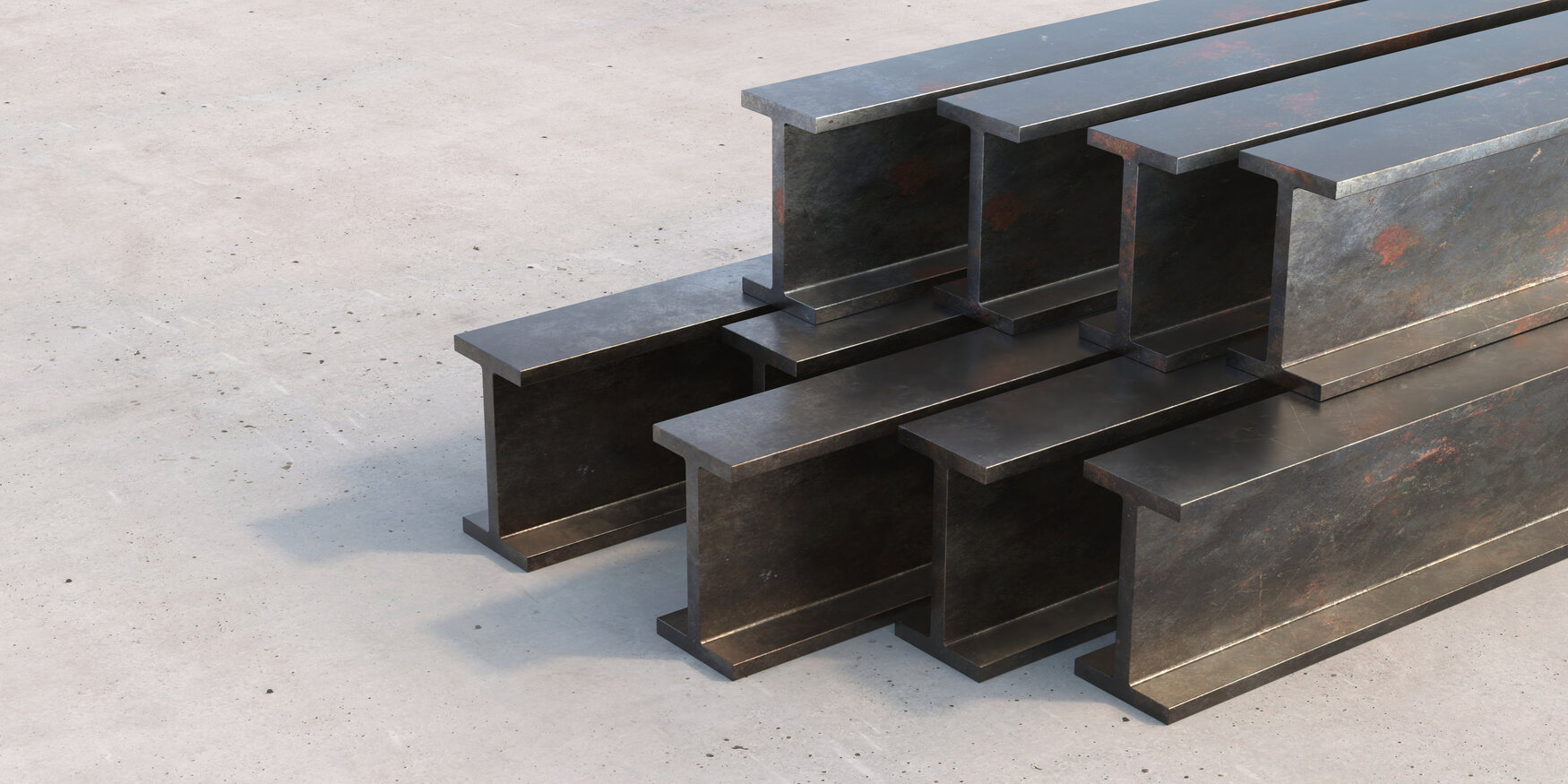 Steel I beams piled in an outdoor yard