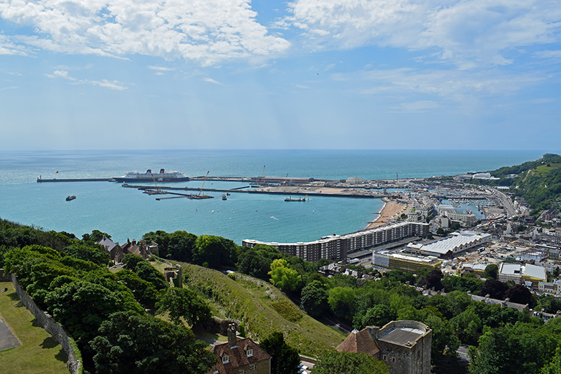 Stock image of the Port of Dover, UK, from land, showing the harbourfront and blue sky and sea beyond
