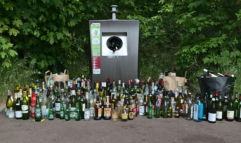 Bottle recucling bank surrounded by bottles