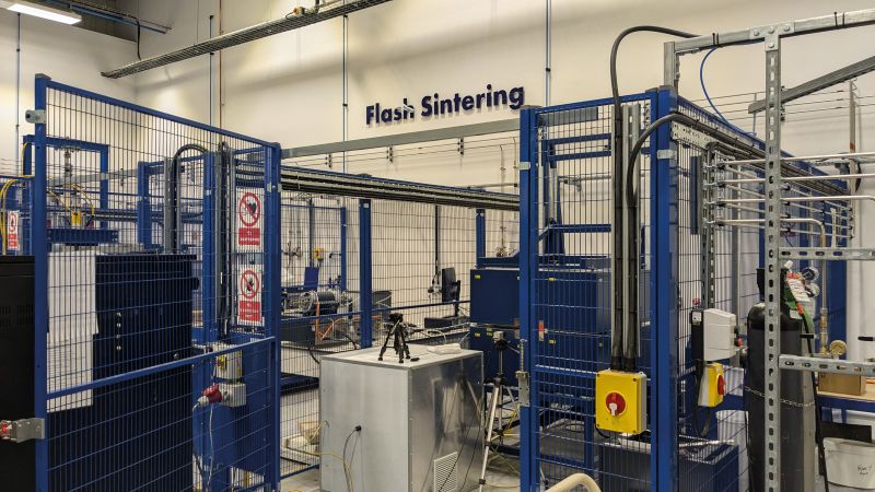 Lucideon’s flash sintering Technology pictured looks like blue cages surrounding a selection of metallic equipment