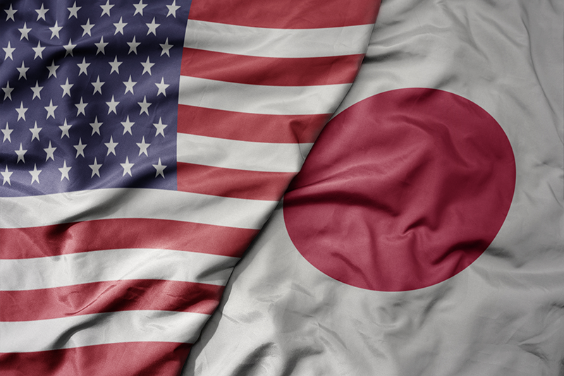 Stock image of the US and Japan flags next to each other