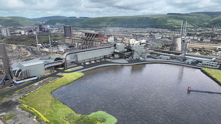 View of the steelworks an Pontypridd, water in front of shot with industrial buildings to the rear
