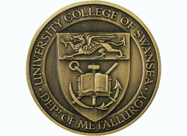 bronze medal, text surrounging reads University College of Swansea Dept of metallurgy, top centre a boxed dragon facing left below sit mining symbols