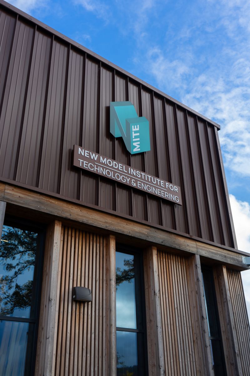 The New Model Institute for Technology and Engineering (NMITE)  logo pictured on one of its buildings.