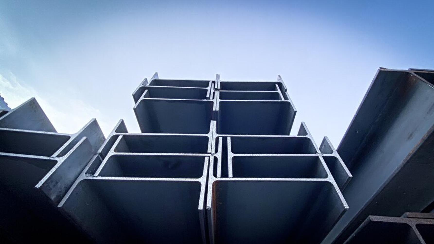 Looking up at steel I beams against a blue sky
