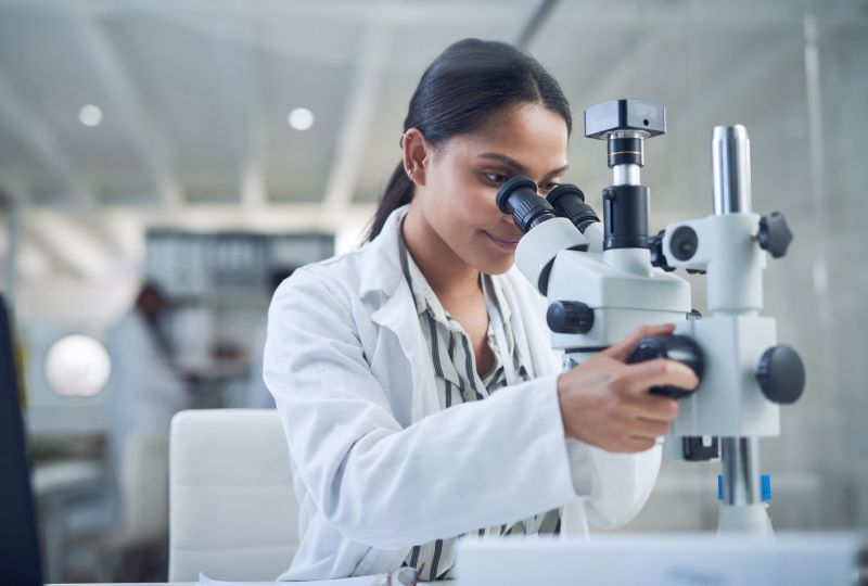 Science, microscope and innovation with a woman in a laboratory concept pictured