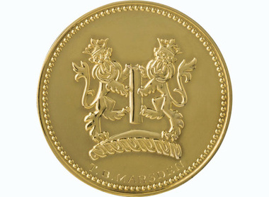 Gold circular medal with heraldic lions and the text below reading T. B. Marsden