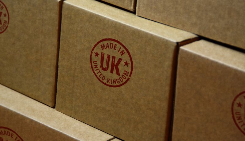 Made in UK stamp printed on cardboard box. Factory, manufacturing and production concept.