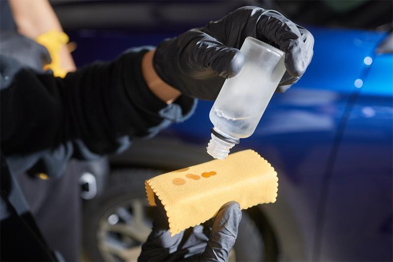 worker applying nanoceramic coating onto cloth