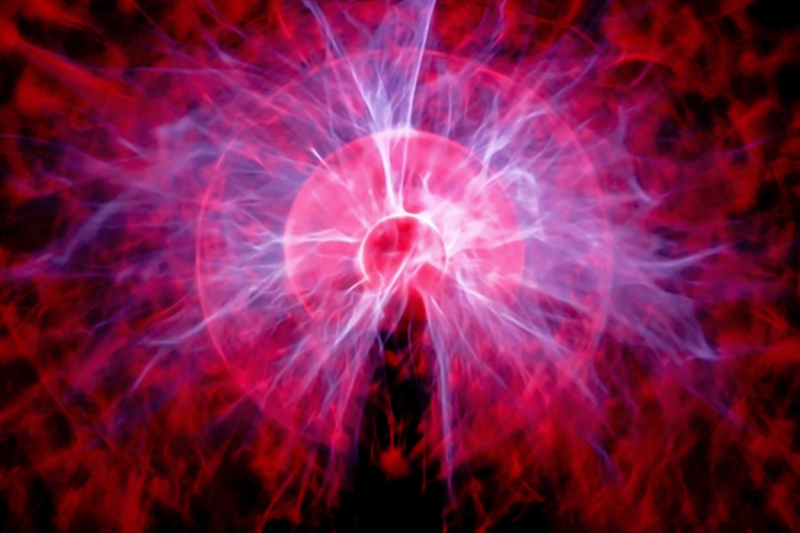 An artistic interpretation of a particle with electrical charges /waves emitting from it