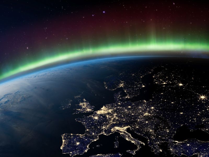 The earth shown from space, with the rim showing space in the background highlighted by the atmosphere