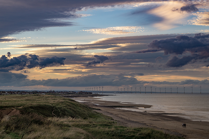 coastline with offshore windfarm in the distance