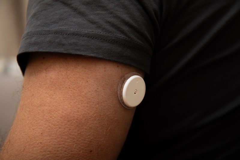 a close up of a white sensor on the arm of a person