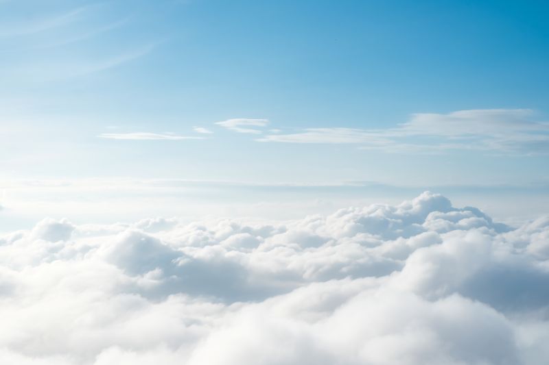 shot from above the cloudline showing clouds below stretching into the distance