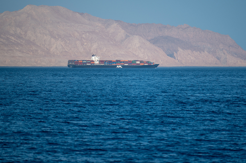: Iranian coastline near the Strait of Hormuz with large sea container ship