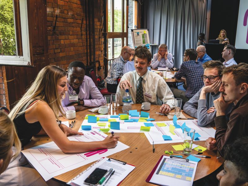 People brainstorming at a table pictured