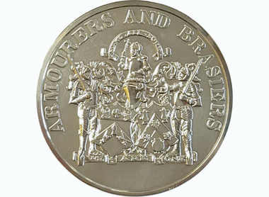 silver coloured circular medal, text reads Armourers and Brasiers, beneath are three knights in armour