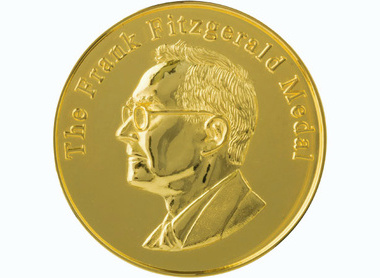 gold circular medal with raised lettering reading The Frank Fitzgerald Medal, profile of Fitzgerald beow faces left, wears glasses
