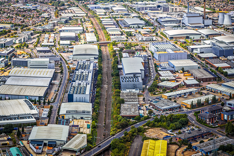 Stock drone image of Slough Trading Estate, one of Europe’s largest industrial business parks, with warehouses, factories, and nearby residential zones