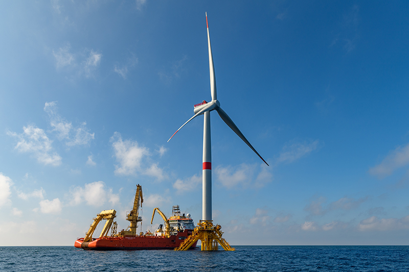 offshore wind turbine with a ship behind