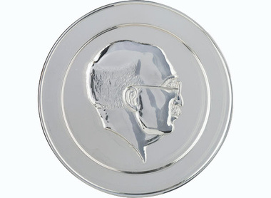 circular silver medal with raised centre featuring right facing profile