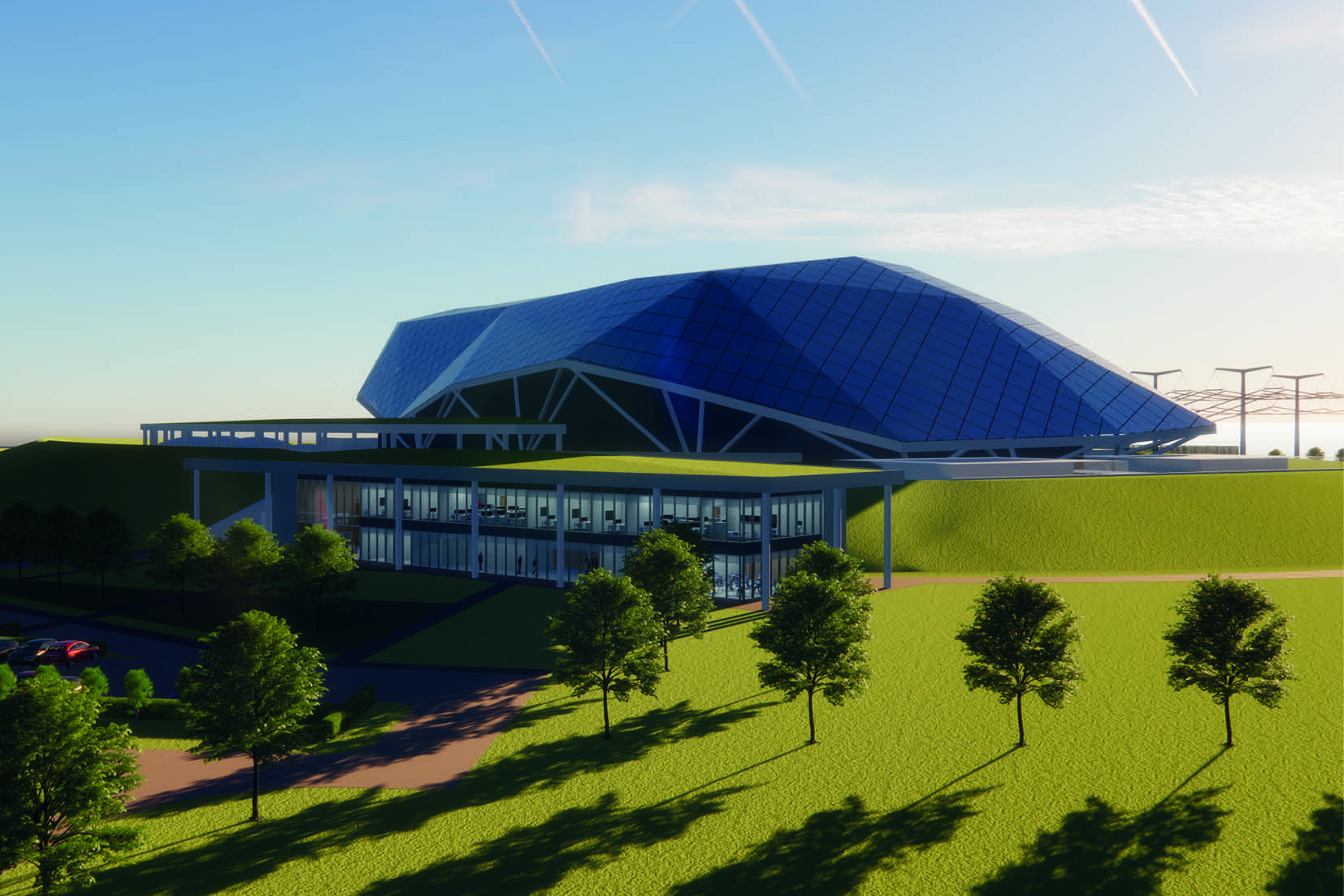 A low building in a grassy area with trees