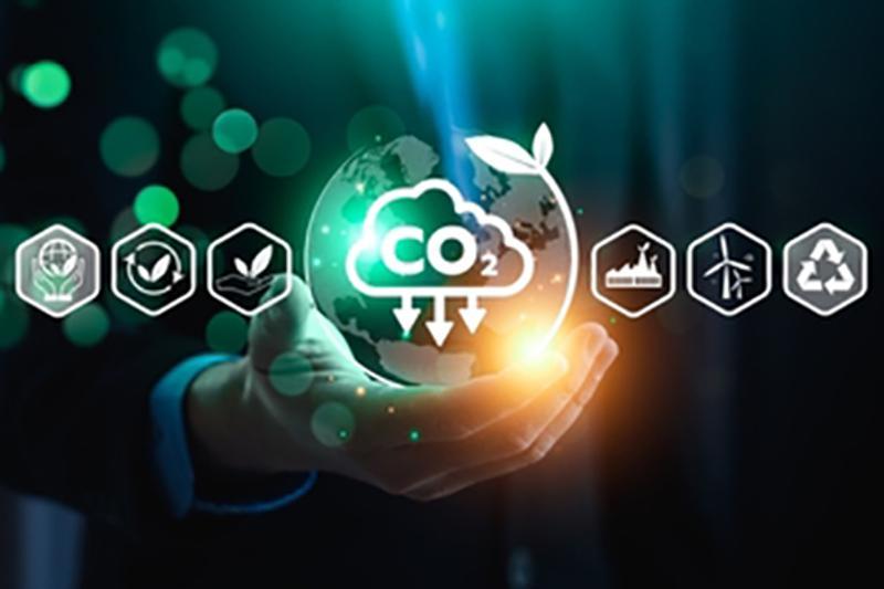hand holding a bubble flanked by sustainability icons indicating CO2 capture