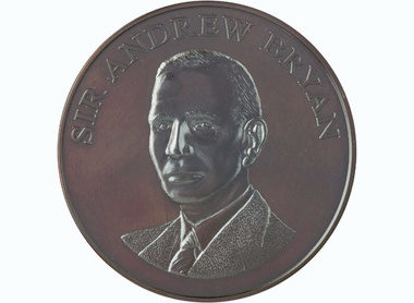 bronze circular medal with text reading Sir Andrew Bryan at the top edge, image depicting him centre looking to the left