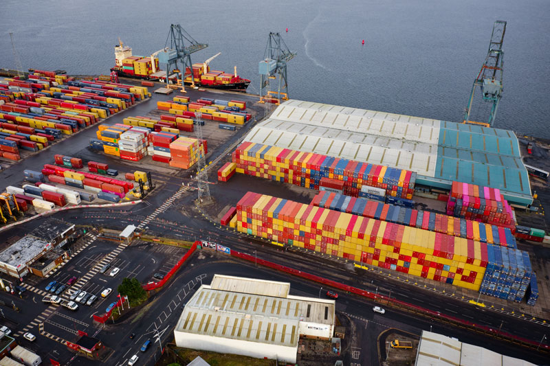 Shipping dock with multicoloured shipping containers