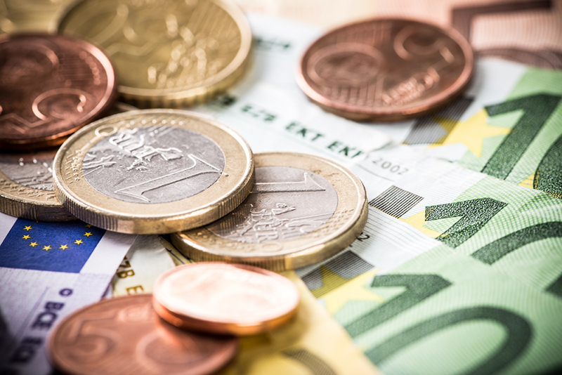 Euro coins scattered over Euro notes