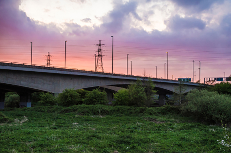 Clifton bridge in Nottingham with the sunset behind and pylons in the background
