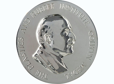Silver medal with raised writing at the edge reading The Plastics and Rubber Institute Colwyn Medal, centred is a right facing profile of Colwyn