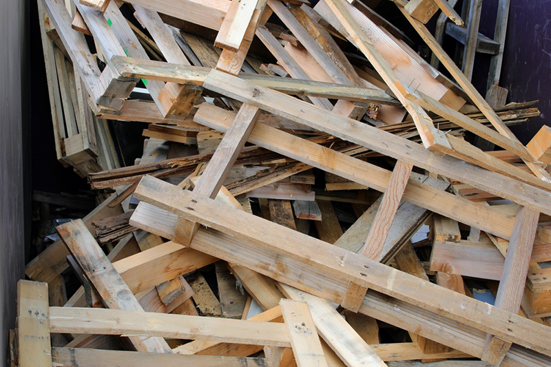 Large industrial waste container filled with wooden pallets ready for recycling at an recycling facility