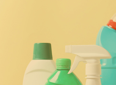 pale yellow background with top parts of various plastic bottles