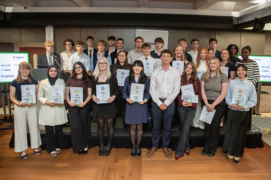 Group of Starpack competition winners standing in a line holding awards