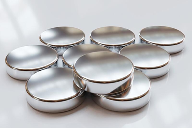 Close up of silver-coloured neodymium magnets arranged in an artful stack