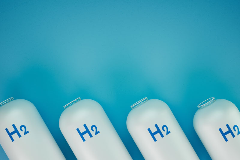 the top section of four canisters labelled H2 leaning to the right with a plain turquoise background
