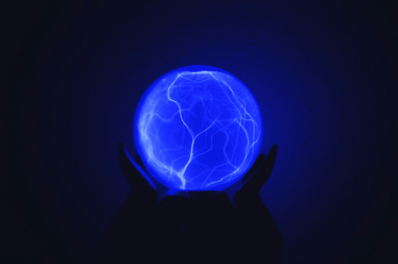 Blue glowing electric ball against a black background
