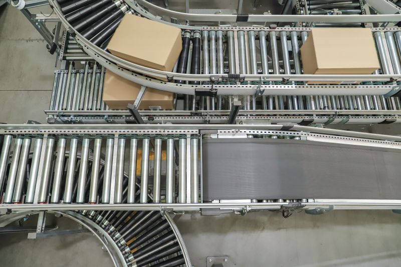 Curving conveyor belt transporting boxes pictured