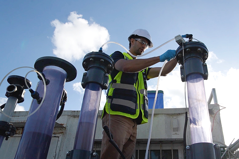 Person inhard hat and high-viz vest works on water pipes